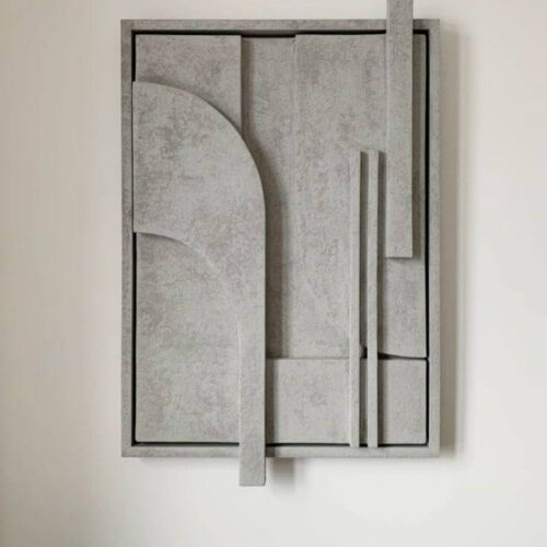 Tableau relief 3D modernre accroché sur un mur semi-blanc.